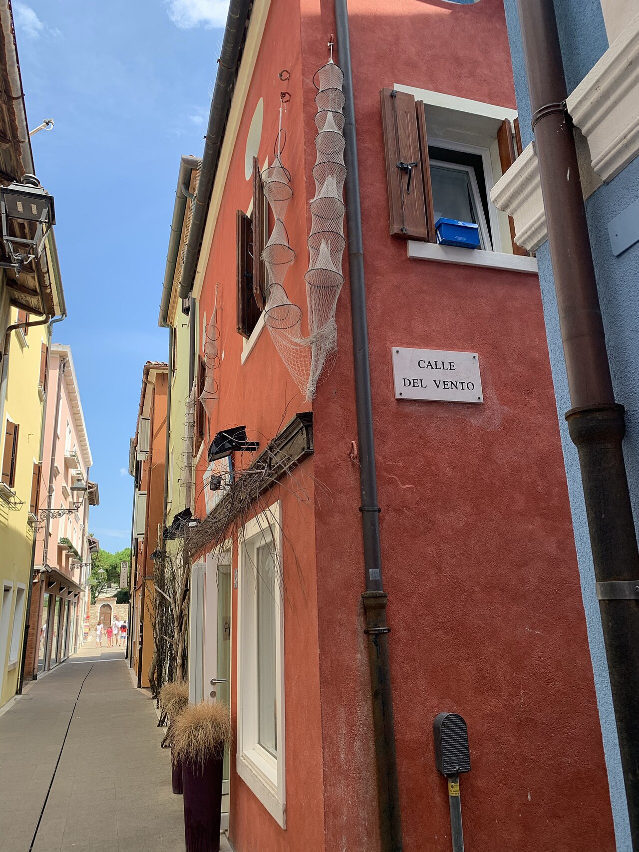 A narrow lane in the old centre of Caorle, with the pastel-painted houses typical of Venetian seaside villages