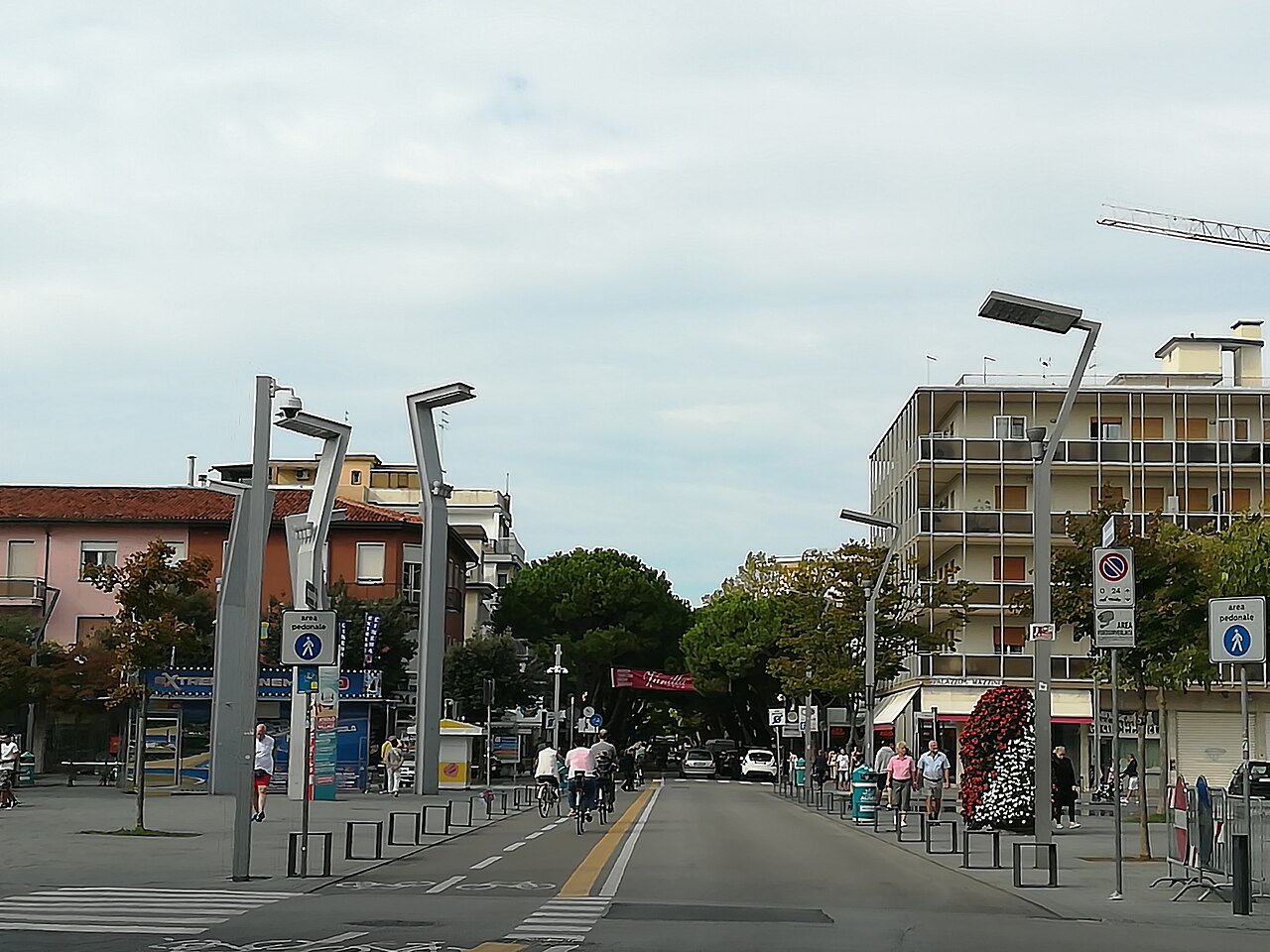 The seafront of Jesolo Lido seen from the pier, with the coastline running away to the east on a summer day